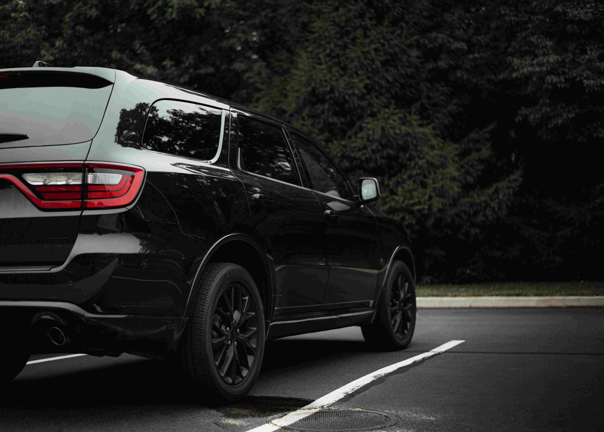 A Dodge Durango parked in front of trees.