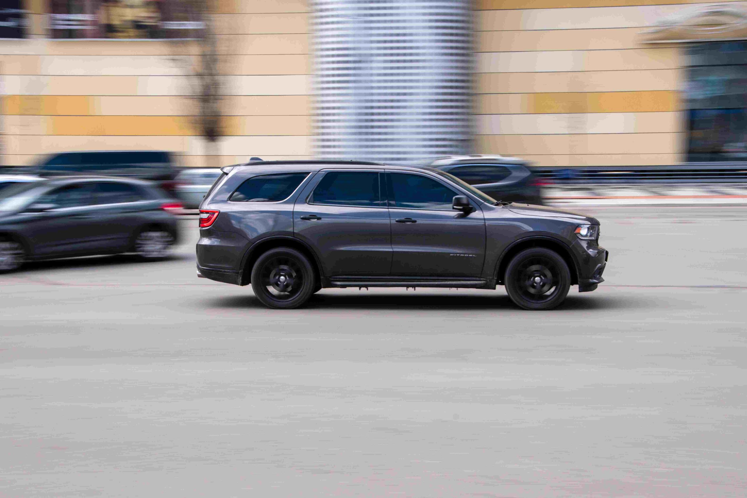 A Dodge Durango drives in a parking lot.