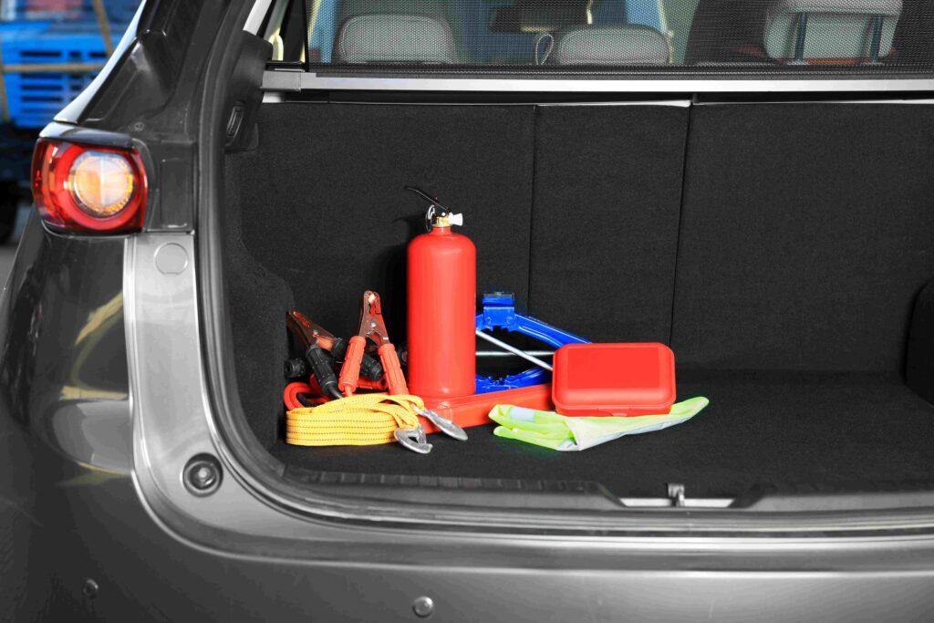 An emergency car kit in the trunk of a car.